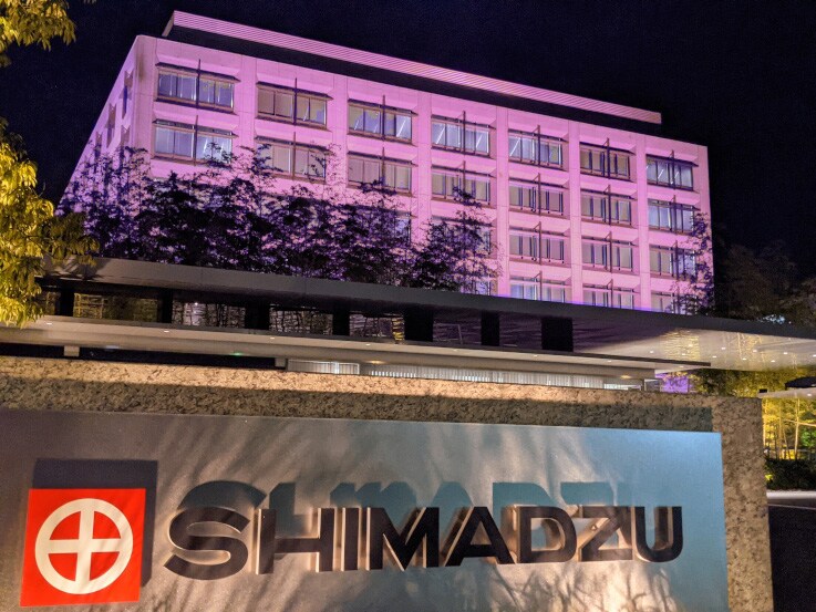 The Shimadzu Head Office building lit up in pink.