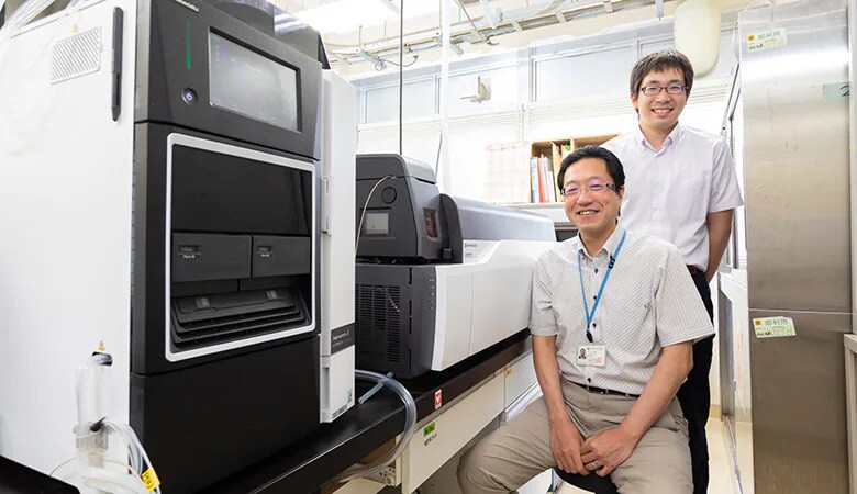 Shimadzu Liquid Chromatograph Mass Spectrometer with Dr. Kozo Nakamura (front) and Dr. Masahiro Koyama, CEO of Wellnas. Co., Ltd. (rear)