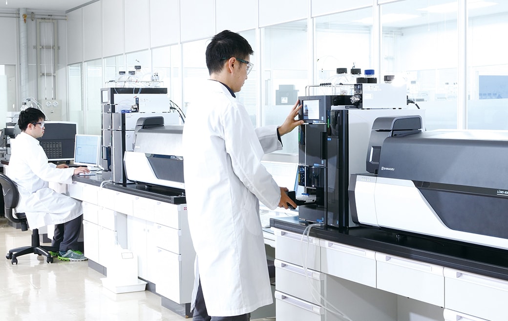 Analytical chemists using Shimadzu's liquid chromatograph-mass spectrometry systems in their laboratory.