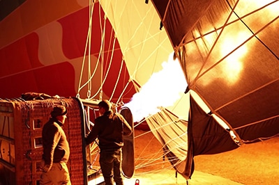 Preparing for the flight. Buoyancy is obtained by using a burner to heat the air, which fills up the balloon (envelope)