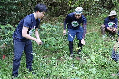 Wearing matching T-shirts, the group planted trees together