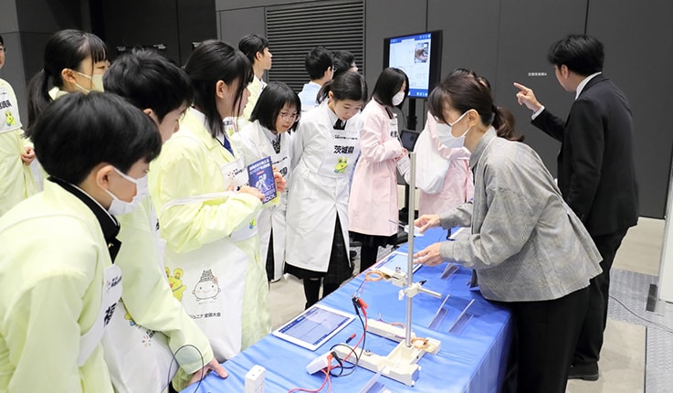 Members of the winning team also visiting the Shimadzu RIKA Corporation booth