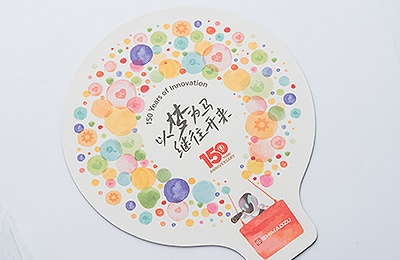 A smartphone stand and mouse pad featuring the anniversary logo (produced by SSL)