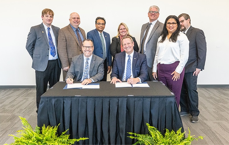 Signatories to this academic partnership, Dr. Kyle Marrero (front left), President at Georgia Southern University, and Patrick Fromal (front right), President of SSI